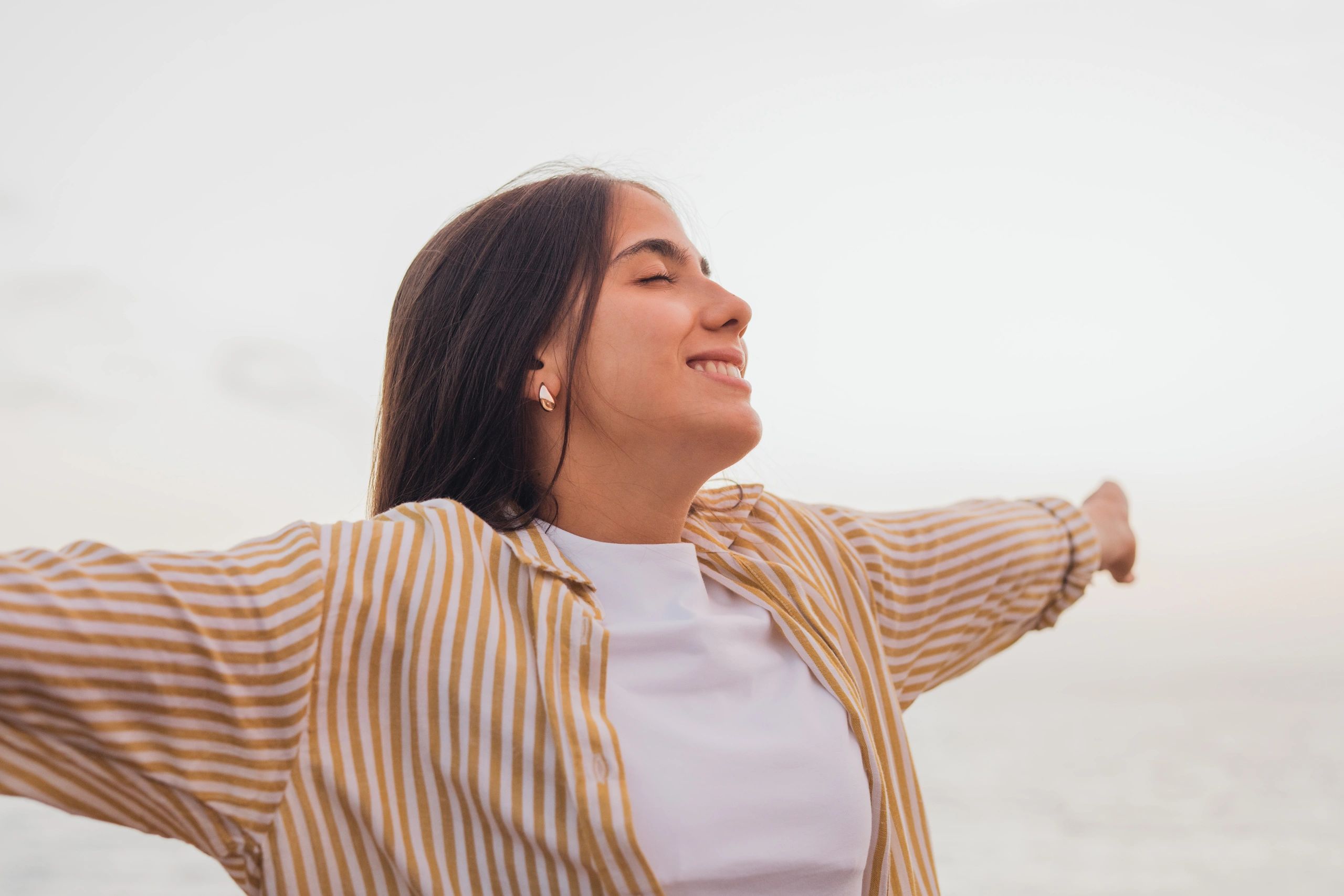 Young woman enjoying freedom with outstretched arms